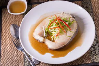 Soya soslu beyaz tabak içinde kar balık buğulama