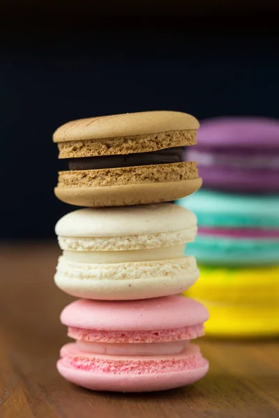 Tasty macaroons with almond on wooden background — Stock Photo, Image