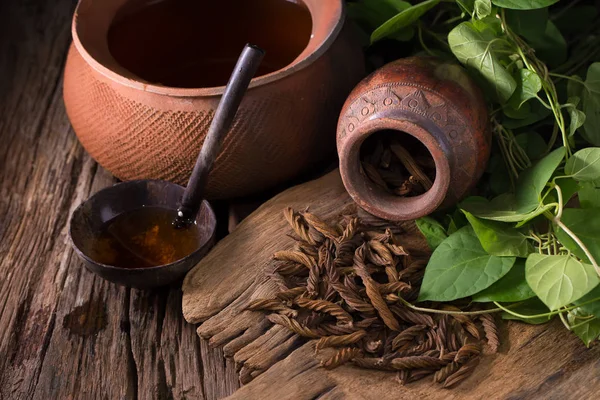 East Indian screw tea and cup of tea on wooden background