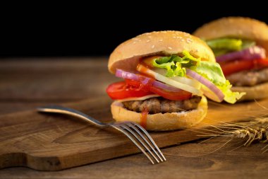 Peynirli hamburger ızgara et, peynir, domates Ahşap yüzeyi ile