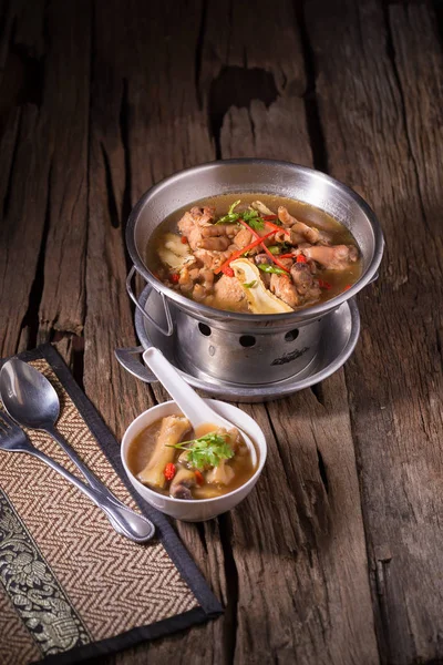 Chicken and herb soup in pot