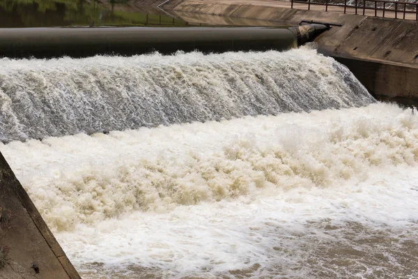 Water over rubber dam blocking river for agriculture