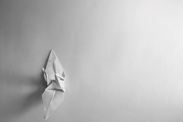 Paper bird on white paper background