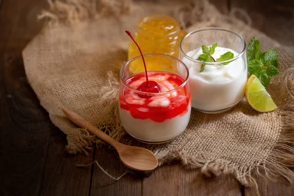 Glas Körsbär Yoghurt Och Mynta Citron Yoghurt Brunt Träbord — Stockfoto