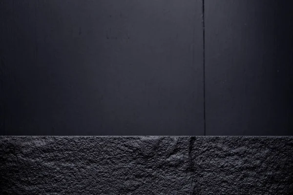 Dark stone board on dark wooden table