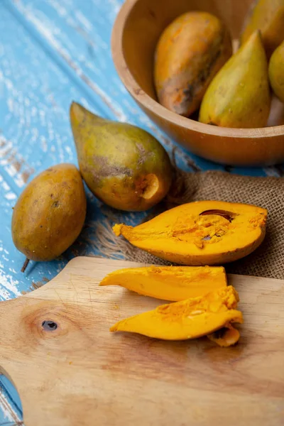 Egg fruit Canistel Yellow Sapote on blue wooden table