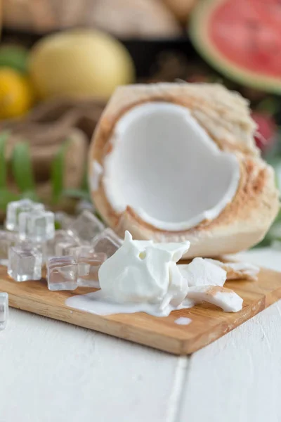 Coconut Ice Cream and Young Coconut on wooden board with ice cubes