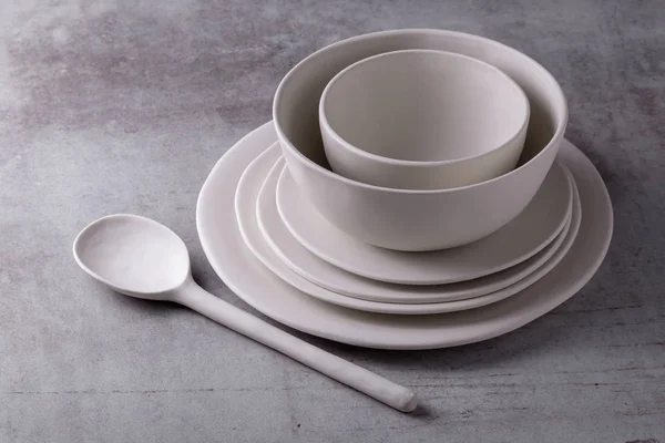 Empty blank white ceramic dish and white spoon ceramic on Cement Board.