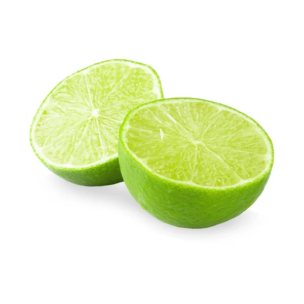 Połowa z plasterkiem limonki zielonej na białym tle — Zdjęcie stockowe