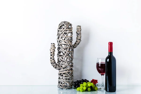 cactus in room decoration at home, wine bottle and wine glass on white background. Home decor with copy space for your text. The concept of a healthy lifestyle, sport, diet.