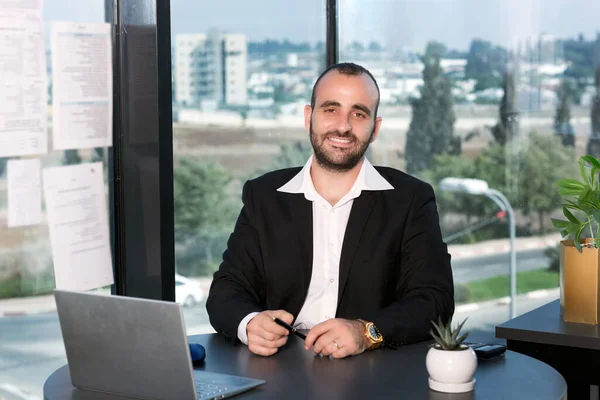 businessman sitting at table with laptop in office. Business, working late concept. I couldn\'t have chosen a better career