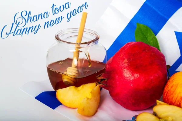 Rosh hashanah (jewish New Year holiday) concept. Traditional symbols. Text SHANA TOVA means HAPPY NEW YEAR in hebrew