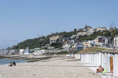 Le Havre, Fransa - 20 Ağustos 2018: İnsanlar Le Havre, Normandy, Fransa için renkli plaj kabin yakınındaki plajda sakin ol