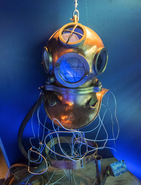 Cherbourg, France - August 26, 2018: Copper diving helmet in the maritime museum La Cite de La Mer or City of the Sea in Cherbourg, Normandy, France