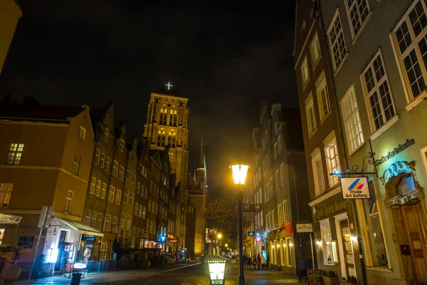 Rue Piwna et vue sur la tour de la basilique Sainte-Marie la nuit. Gdansk, Pologne — Photo