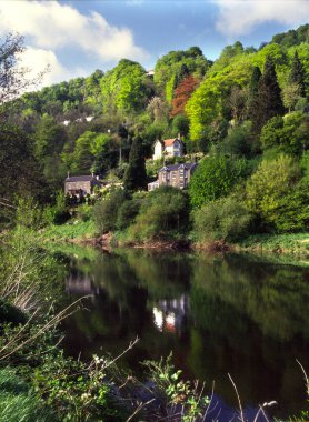 Riverside homes on hillside, River Wye, Wye Valley, Forest of Dean, Herefordshire, England, UK, Europe clipart