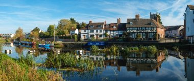 24 Ekim 2018 - Tewkesbury, İngiltere: Tewkesbury, Gloucestershire, Severn Vale, Birleşik Krallık 'taki Abbey Mill yakınlarındaki sakin nehir Avon' a yansıyan resimli bir kulübe grubunun panoramik görüntüsü