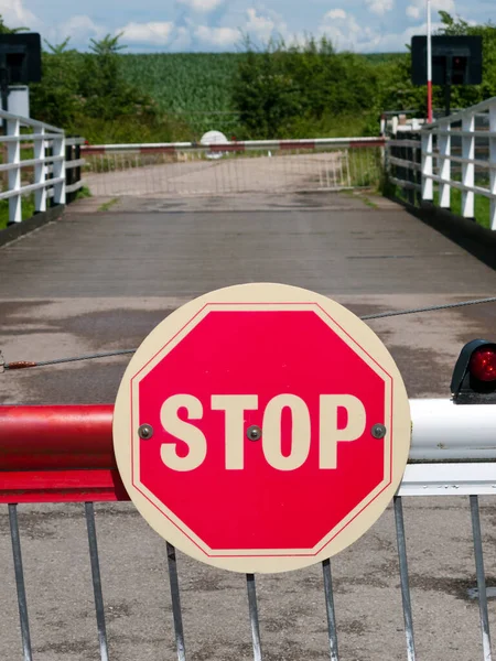 Stop sign on a barrier of a swing bridge over the Gloucester and Sharpness Canal, UK