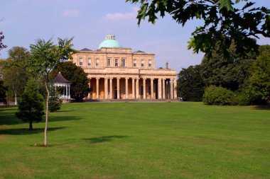 The famous Pump Rooms old spa mineral water buildings in Pittville Park, Cheltenham, Gloucestershire,UK clipart