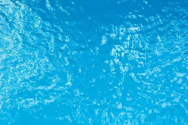 青いスイミングプールの表面の波紋に反射光 — ストック写真