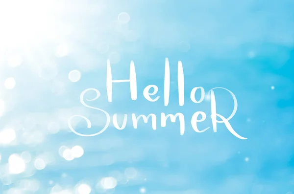 Hello summer words on blur tropical beach with bokeh sun light wave abstract background. Copy space of outdoor summer vacation and travel adventure concept. Vintage tone filter effect color style.