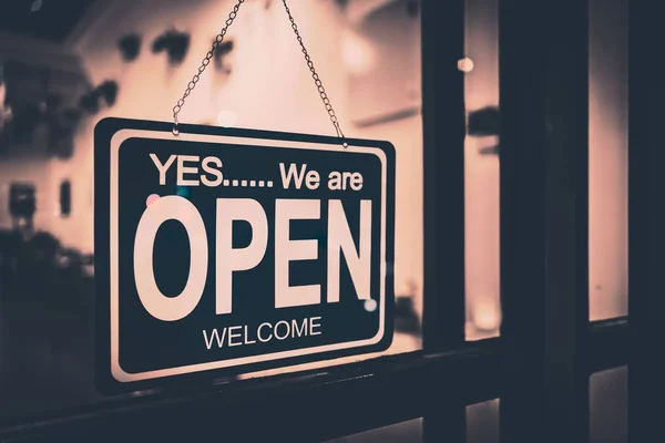 Open sign broad through the glass of door in cafe. — Stock Photo, Image