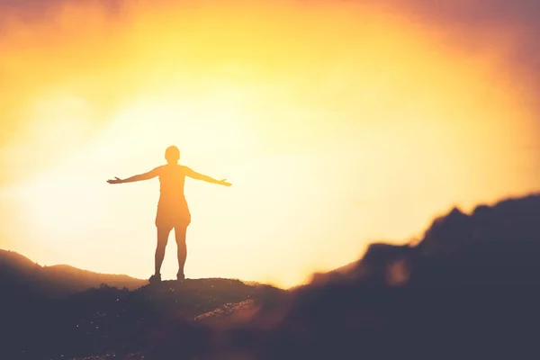 Copy space of woman rise hand up on top of mountain and sunset sky abstract background. — Stock Photo, Image