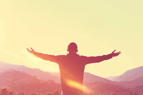 Copy space of man raise hand up on top of mountain and sunset sky abstract background. — Stock Photo, Image