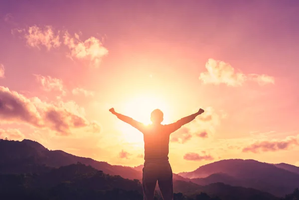 Copy space of man raise hand up on top of mountain and sunset sky abstract background. — Stock Photo, Image