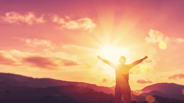 Copy space of man rise hand up on top of mountain and sunset sky abstract background. — Stock Photo, Image