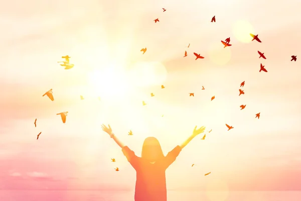 Copy space of woman raise hand up on sunset sky at beach and island background. — Stock Photo, Image