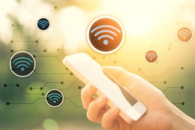 Kadın el açık doğa parkı ve wifi simge hattı soyut arka plan ile günbatımı gökyüzü akıllı telefon kullanarak. Kopya uzay teknolojisi iş ve seyahat doğa tatil konsepti. Vintage ton filtre rengi 