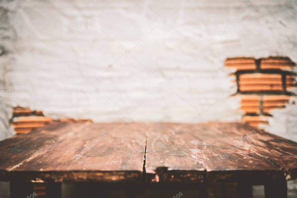 Copy space of old wooden table top on brown stone wall texture abstract background. 