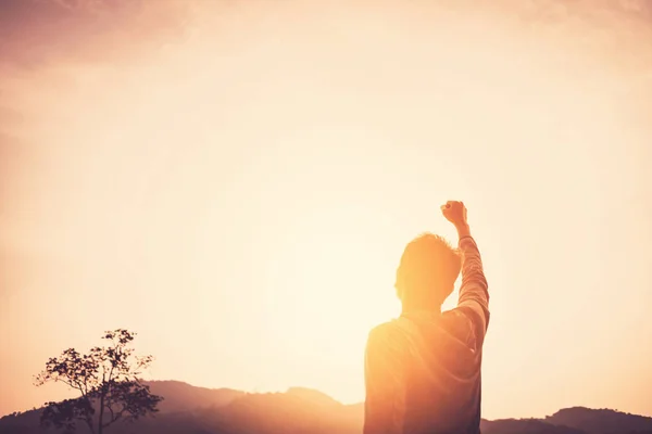 Copy space of man rise hand up on top of mountain and sunset sky abstract background. — Stock Photo, Image