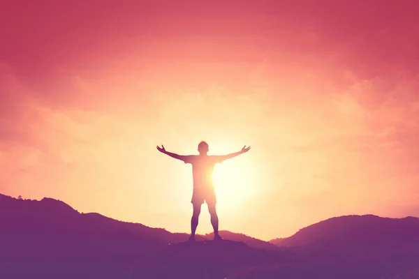 Copy space of man rise hand up on top of mountain and sunset sky abstract background. — Stock Photo, Image
