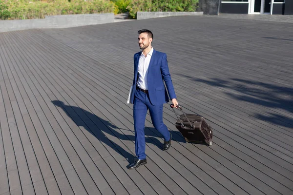 Young executive businessman walking around the airport for work trip