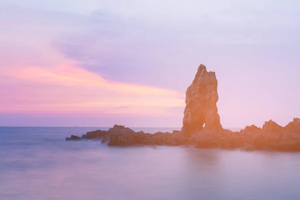 Natural rock over sea shore skyline after sunset tone, landscape background