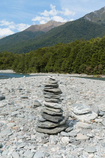 Stack river stone on ground with mountain background