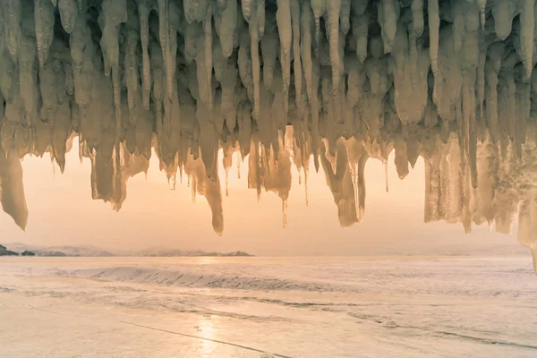 Freezing waterfall in ice cave in Baikal water lake Russia winter season natural landscape background