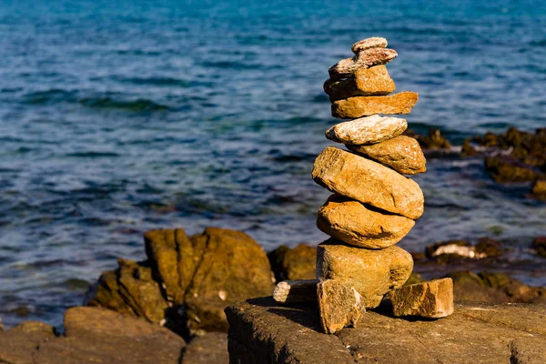 Balance stack stone on seacoast, abstract background