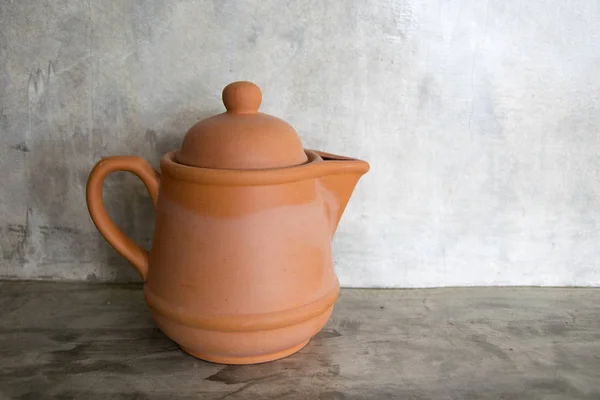 Tea pot baked clay  on cement background — Stock Photo, Image