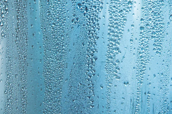 Wassertropfen Auf Blauem Glas Bokeh Textur Hintergrund Mit Defokussierten Lichtern — Stockfoto