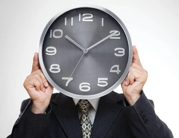 Close Businessman Covering His Face Analog Clock Isolated Gray Background — Stock Photo, Image