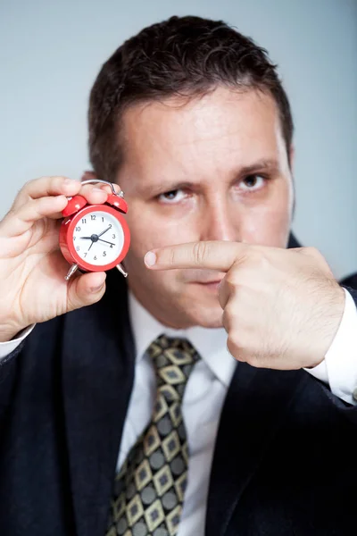 Angry Young Businessman Holds Alarm Clock Isolated — Stock Photo, Image