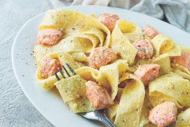 Papardelle makarna, somonlu kremalı sos, doğal ışık, yaşam tarzı, ev yapımı, gri arka planda insan yok.,
