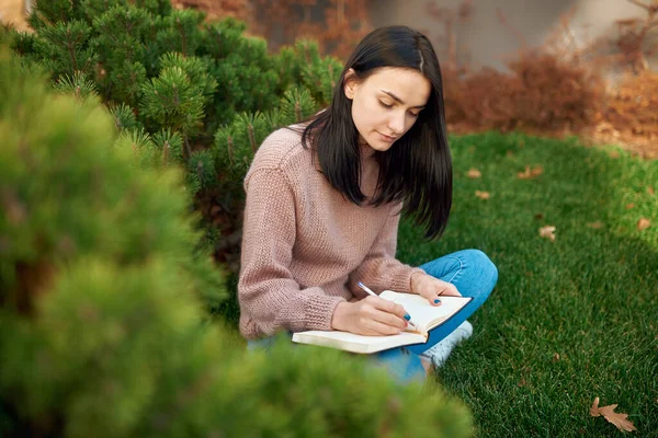 Pleasant Young Brunette Long Hair Concentrated Writing Page Her Notebook — Stock Photo, Image