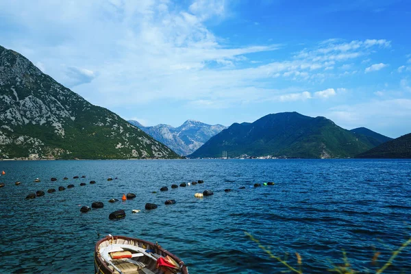 Dağ gölü, dağlar, tekne manzarası. Dağ manzarası. İstiridye çiftliği. Kotor ve Perast 'ın bulunduğu kayalık kıyılarda bulunan fiyort benzeri ünlü körfez. Boko Kotor Körfezi.