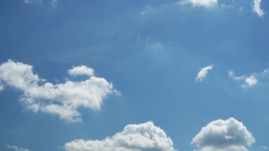 Kar beyazı kabarık bulutlar mavi gökyüzünde hızla hareket eder. Zaman ayarlı görüntüler. Arkaplan.