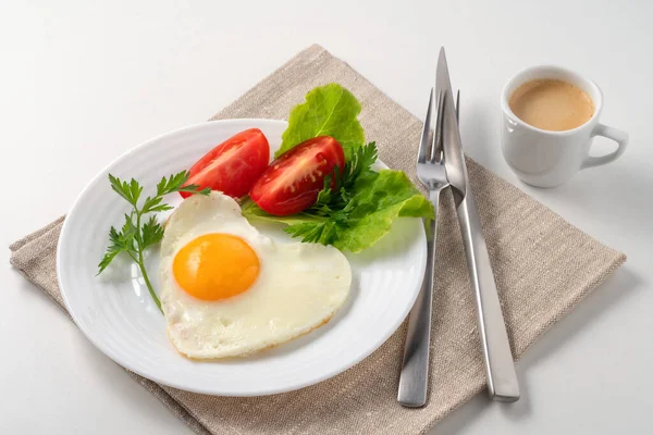 Food poster - Healthy and hearty breakfast. Close-up of a fried eggs, tomato, herbs and espresso coffee. Served on a white table with a linen napkin and cutlery. Meet my favorite fried egg: the crispy olive oil fried egg. These fried eggs have golden