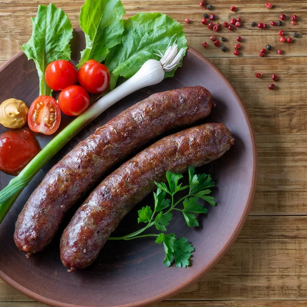 Food poster, restaurant setting - a portion of grilled sausages with tomatoes and herbs, ketchup, mustard. On a rustic table.